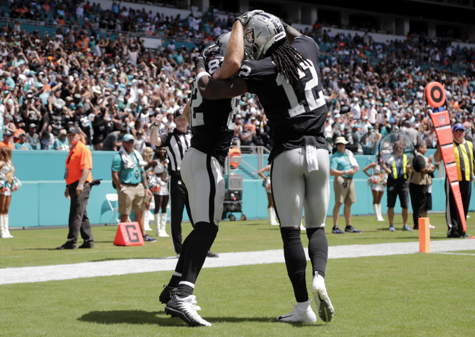 Oakland Raiders wide receiver Jordy Nelson, left, is congratulated by wide receiver Martavis Bryant (12) after scoring a touchdown during the first half of an NFL football game against the Miami Dolphins, Sunday, Sept. 23, 2018, in Miami Gardens, Fla. (AP Photo/Lynne Sladky)