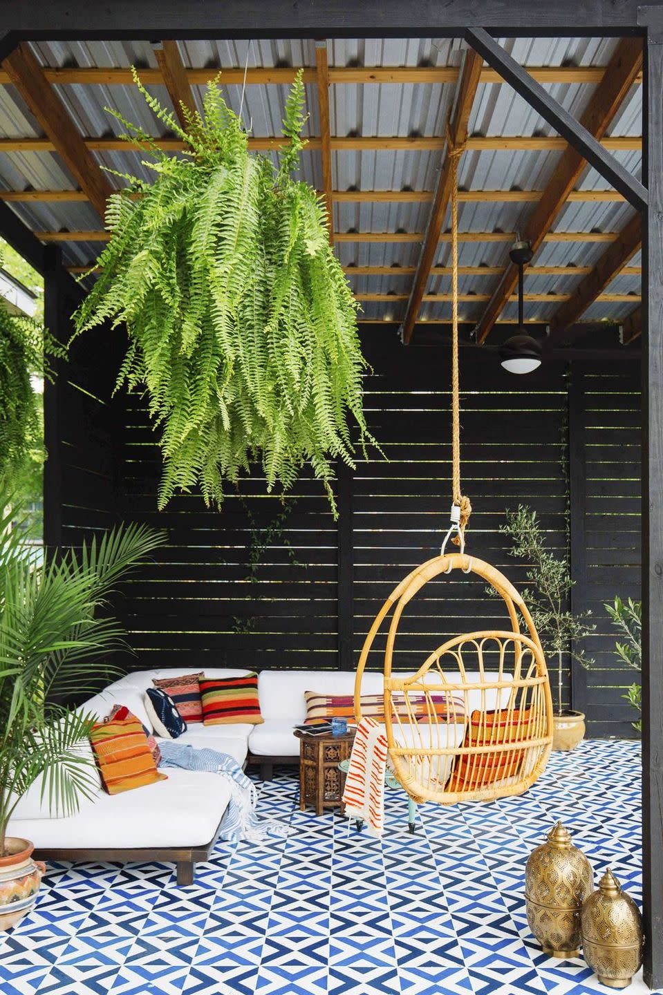 <p>Let your geometric tiling or outdoor rug make a statement by hanging a swing chair from the ceiling or deck cover. The perfect place to catch up on your summer read, don't ya think?</p>