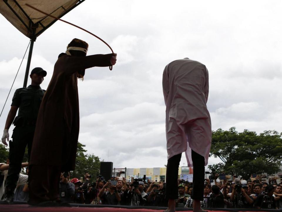 A man is caned in the Indonesian region of Banda Aceh for having gay sex (EPA)