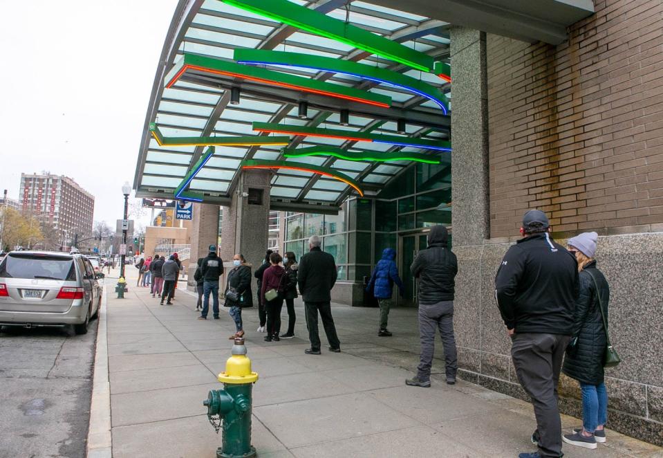 People seeking COVID testing at the Dunkin' Donuts Center on Dec. 29, 2021, line up next door outside the Rhode Island Convention Center.