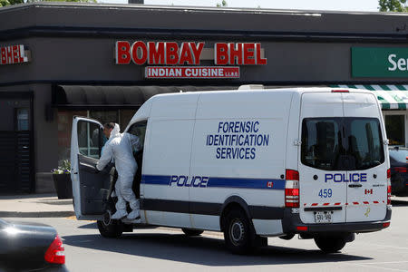 A police forensic investigator gets out of a van to collect evidence at Bombay Bhel restaurant, where two unidentified men set off a bomb late Thursday night, wounding fifteen people, in Mississauga, Ontario, Canada May 25, 2018. REUTERS/Mark Blinch