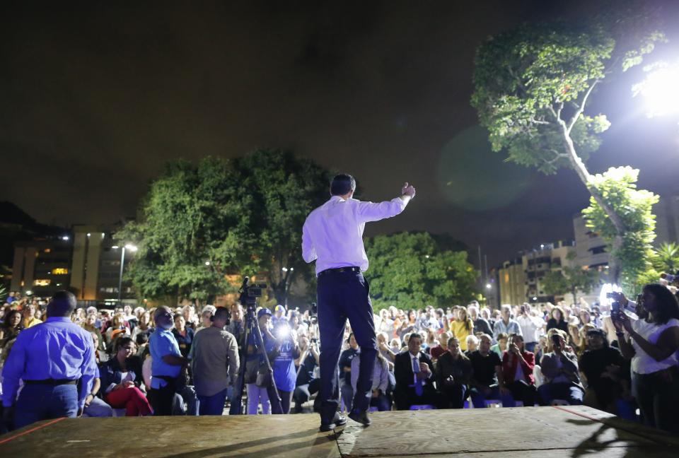 Venezuelan opposition leader and self-proclaimed interim president Juan Guaido speaks during a citizen's meeting in in Caracas, Venezuela, Wednesday, Nov. 13, 2019. Guaido is calling people across the crisis-torn nation to flood the streets for protests nearly a year since launching an urgent campaign to push President Nicolás Maduro from power. (AP Photo/Ariana Cubillos)