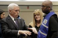 U.S. Vice President Mike Pence, who heads the government's coronavirus task force, speaks with a planning chief at the Washington State Emergency Operations Center during a tour with Governor Jay Inslee at Camp Murray near Tacoma