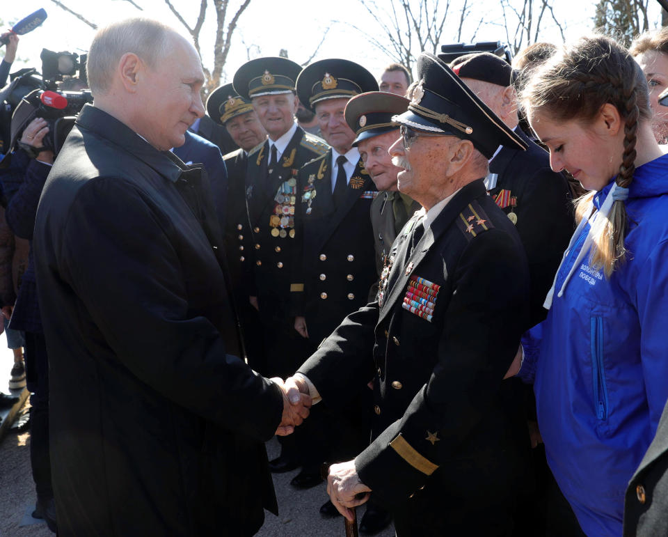 Russian President Vladimir Putin, right, meets with local residents and veterans at the historical memorial the Malakhov Kurgan (Malakoff redoubt) in Sevastopol, Crimea, Monday, March 18, 2019. Putin visited Crimea to mark the fifth anniversary of Russia's annexation of Crimea from Ukraine by visiting the Black Sea peninsula. (Mikhail Klimentyev, Sputnik, Kremlin Pool Photo via AP)