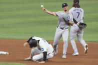 Miami Marlins' Nick Fortes (4) is out as Colorado Rockies shortstop Ezequiel Tovar throws to first base to complete the double play during the fourth inning of a baseball game, Thursday, May 2, 2024, in Miami. (AP Photo/Marta Lavandier)