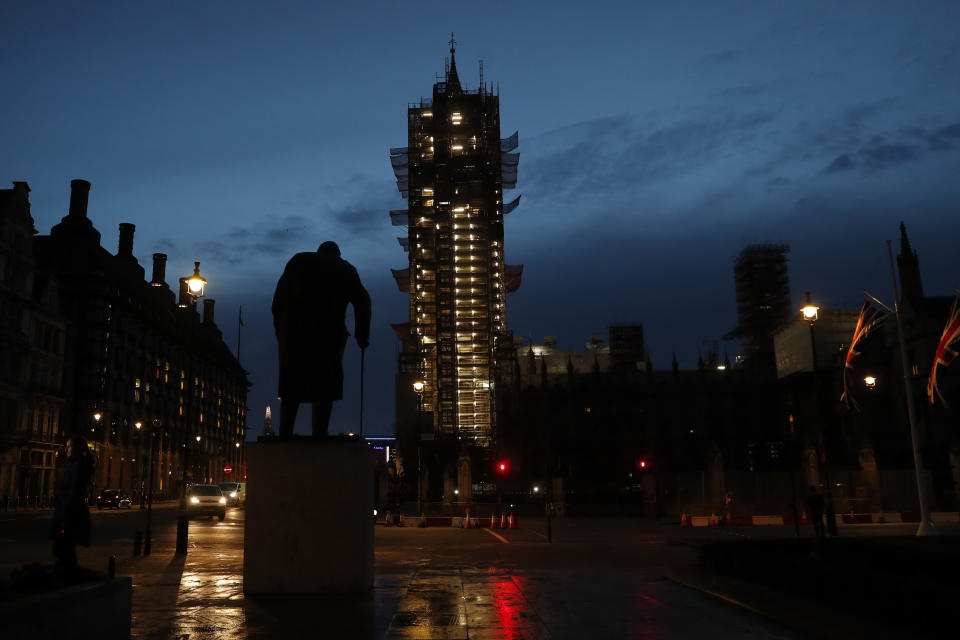 Dawn's first light breaks in Parliament Square with the statue of former British Prime Minister Winston Churchill looking toward the Palace of Westminster in London, Saturday, Feb. 1, 2020. Britain officially left the European Union on Friday after a debilitating political period that has bitterly divided the nation since the 2016 Brexit referendum. (AP Photo/Alastair Grant)