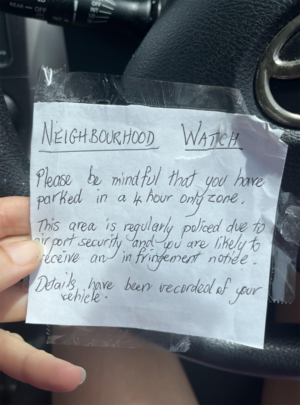 The note written to the driver about their parking job.