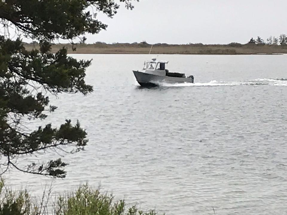 A fishing boat cruises Ninigret Pond in the Ninigret National Wildlife Refuge in Charlestown.