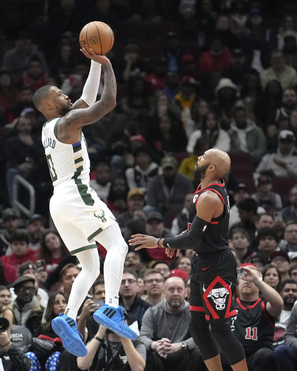 Milwaukee Bucks' Damian Lillard shoots over Chicago Bulls' Jevon Carter during the first half of an NBA basketball game, Thursday, Nov. 30, 2023, in Chicago. (AP Photo/Charles Rex Arbogast)