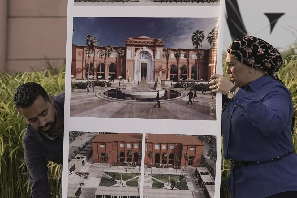 Egyptian museum officials hang the planner of the new fountain at the garden of the Egyptian museum in Cairo, Egypt, Wednesday, Sept. 27, 2023. The country is aiming at reaching 30 million visitors by 2028, as its once-thriving tourism sector has begun to recover from the fallout of the coronavirus pandemic and the grinding war in Europe, Egypt's Tourism and Antiquities Minister Ahmed Issa said during an interview with the Associated Press. (AP Photo/Amr Nabil)