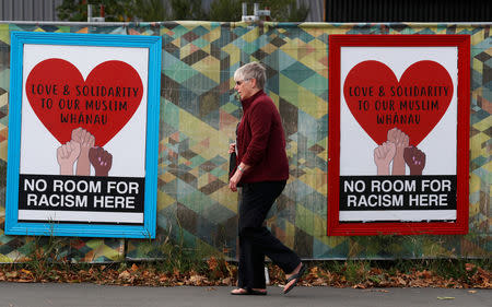 People walk past posters after last Friday's mosque attacks in Christchurch, New Zealand March 21, 2019. REUTERS/Jorge Silva