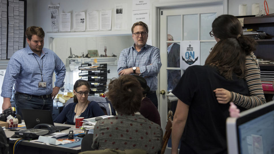 Editor Rick Hutzell, center, gives a speech to his staff including Chase Cook, Nicki Catterlin, Rachael Pacella, Selene San Felice and Danielle Ohl at the Capital Gazette in Annapolis, Md., Monday, April 15, 2019. Hutzell said Monday that his staff experienced some "rollercoaster moments" as it won a special Pulitzer Prize citation for its coverage and courage in the face of a massacre in its own newsroom. "Clearly, there were a lot of mixed feelings," Hutzell told The Associated Press. "No one wants to win an award for something that kills five of your friends." (Ulysses Muoz/The Baltimore Sun via AP)