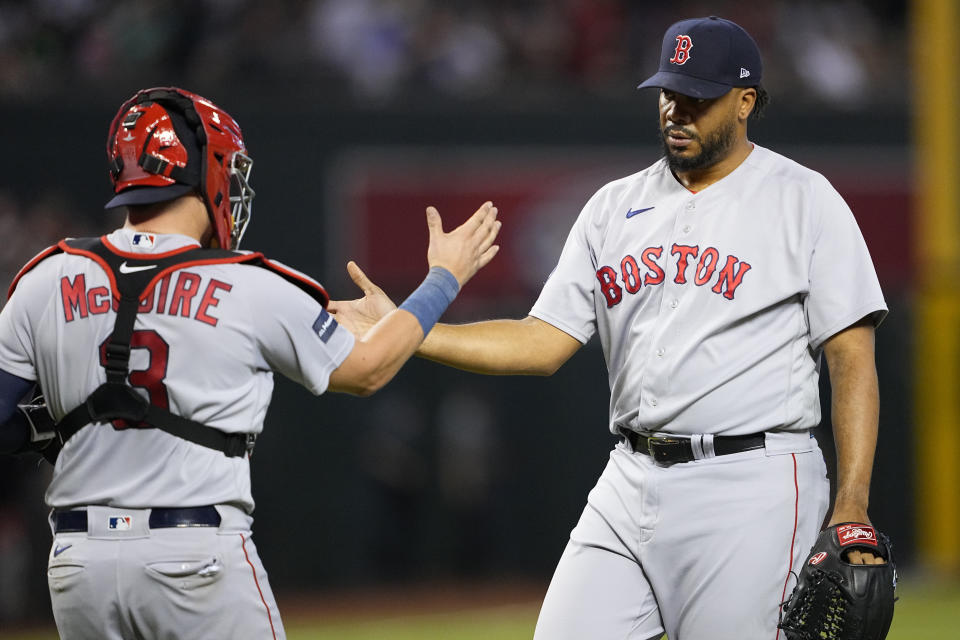 Boston Red Sox relief pitcher Kenley Jansen greets catcher Reese McGuire (3) after a baseball game against the Arizona Diamondbacks, Saturday, May 27, 2023, in Phoenix. The Red Sox defeated the Diamondbacks 2-1. (AP Photo/Matt York)