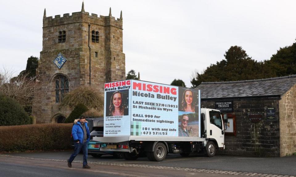 Members of the public walk past information boards in St Michael’s on Wyre appealing for help in the search for Nicola Bulley.