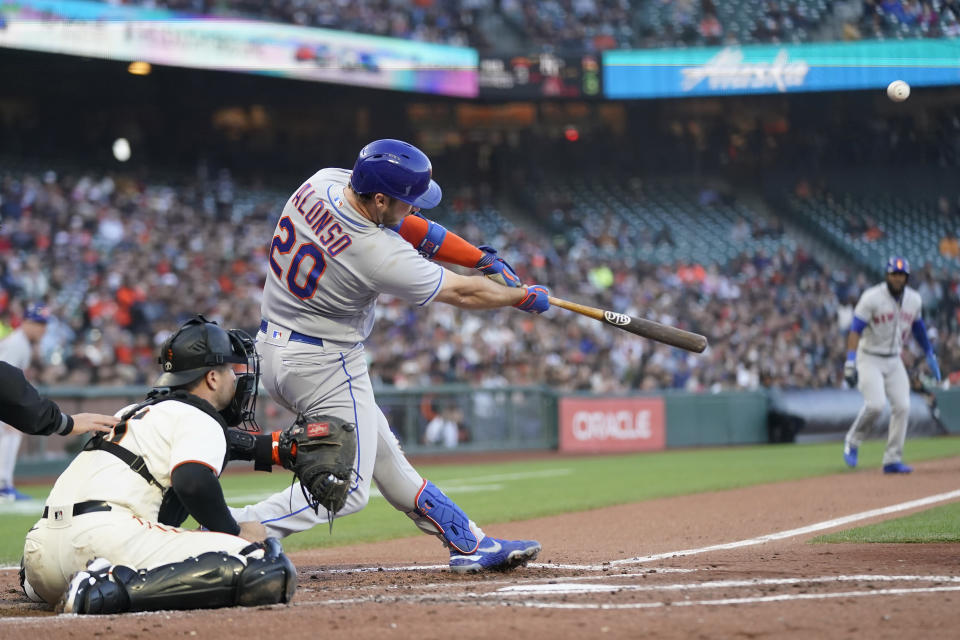New York Mets' Pete Alonso (20) hits a three-run home run in front of San Francisco Giants catcher Joey Bart during the third inning of a baseball game in San Francisco, Monday, May 23, 2022. (AP Photo/Jeff Chiu)