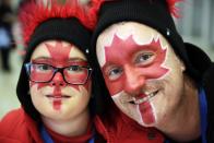 Canadian fans pose for a picture prior to the start of the men's 500-meter speedskating race at the Adler Arena Skating Center at the 2014 Winter Olympics, Monday, Feb. 10, 2014, in Sochi, Russia. (AP Photo/Matt Dunham)