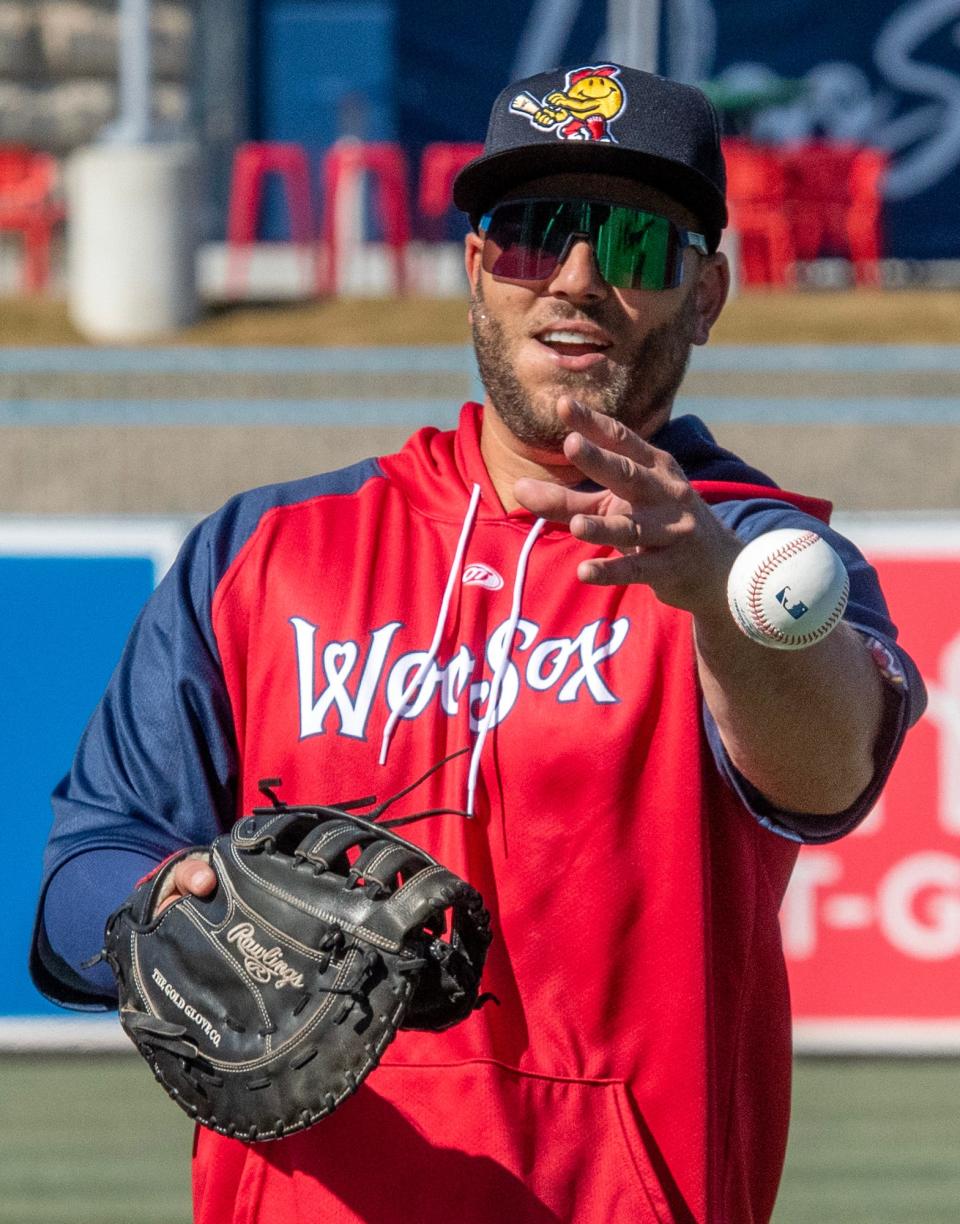 Daniel Palka plays catch before Wednesday's WooSox workout at Polar Park.