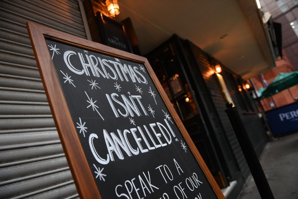 A sign outside a pub advertises a Christmas venue in London on October 21, 2020, as the government considers further lockdown measures to combat the rise in novel coronavirus COVID-19 cases. - Britain has suffered Europe's worst death toll from coronavirus, with nearly 44,000 deaths within 28 days of a positive test result. After a summer lull, cases are rising again as in other parts of the continent -- and so are deaths, with 241 reported on Tuesday alone. (Photo by JUSTIN TALLIS / AFP) (Photo by JUSTIN TALLIS/AFP via Getty Images)