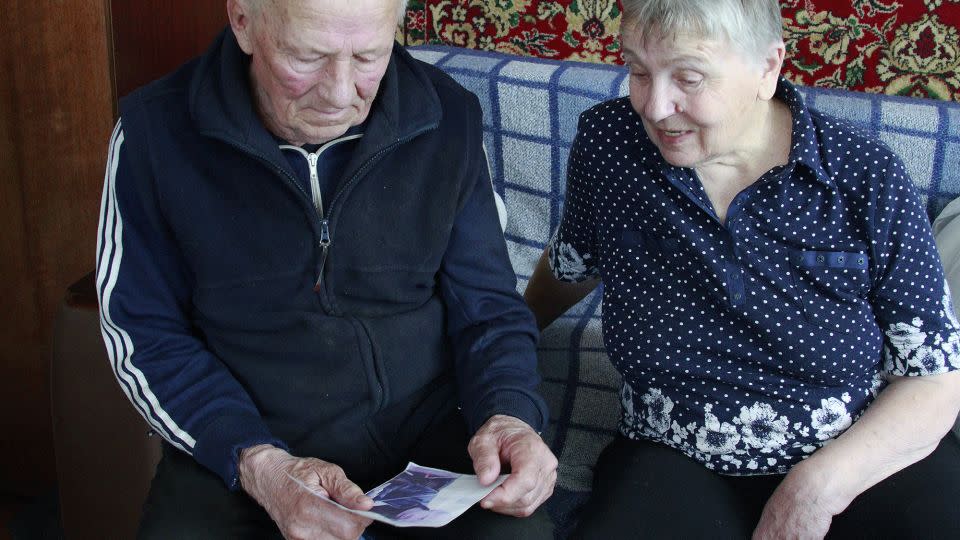 Halyna and Vasyl Khyliuk look at a picture of their son in their home in Kozarovychi, Ukraine. - Ivana Kottasova/CNN