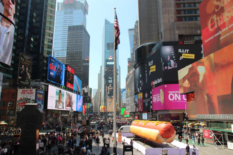 An approximately 65-foot-long hot dog - no less than the world's largest hot dog sculpture - now fills the path of New York's Times Square. Christina Horsten/dpa
