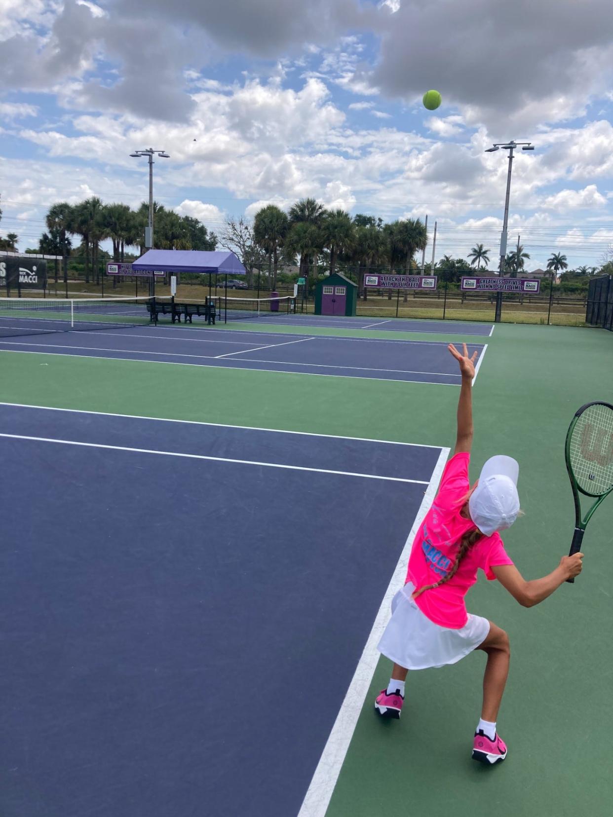 Vlade Hrancher, 8, gets ready to serve during a training session at Boca Raton's Rick Macci Tennis Academy.