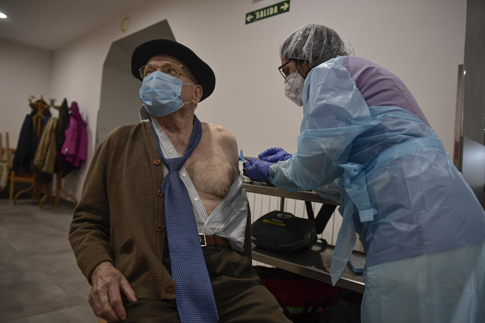 A resident is vaccinated with a second Pfizer coronavirus vaccine at San Jeronimo nursing home, in Estella, around 38 kms (23 miles) from Pamplona, northern Spain, Thursday, Jan. 28. 2021. (AP Photo/Alvaro Barrientos)