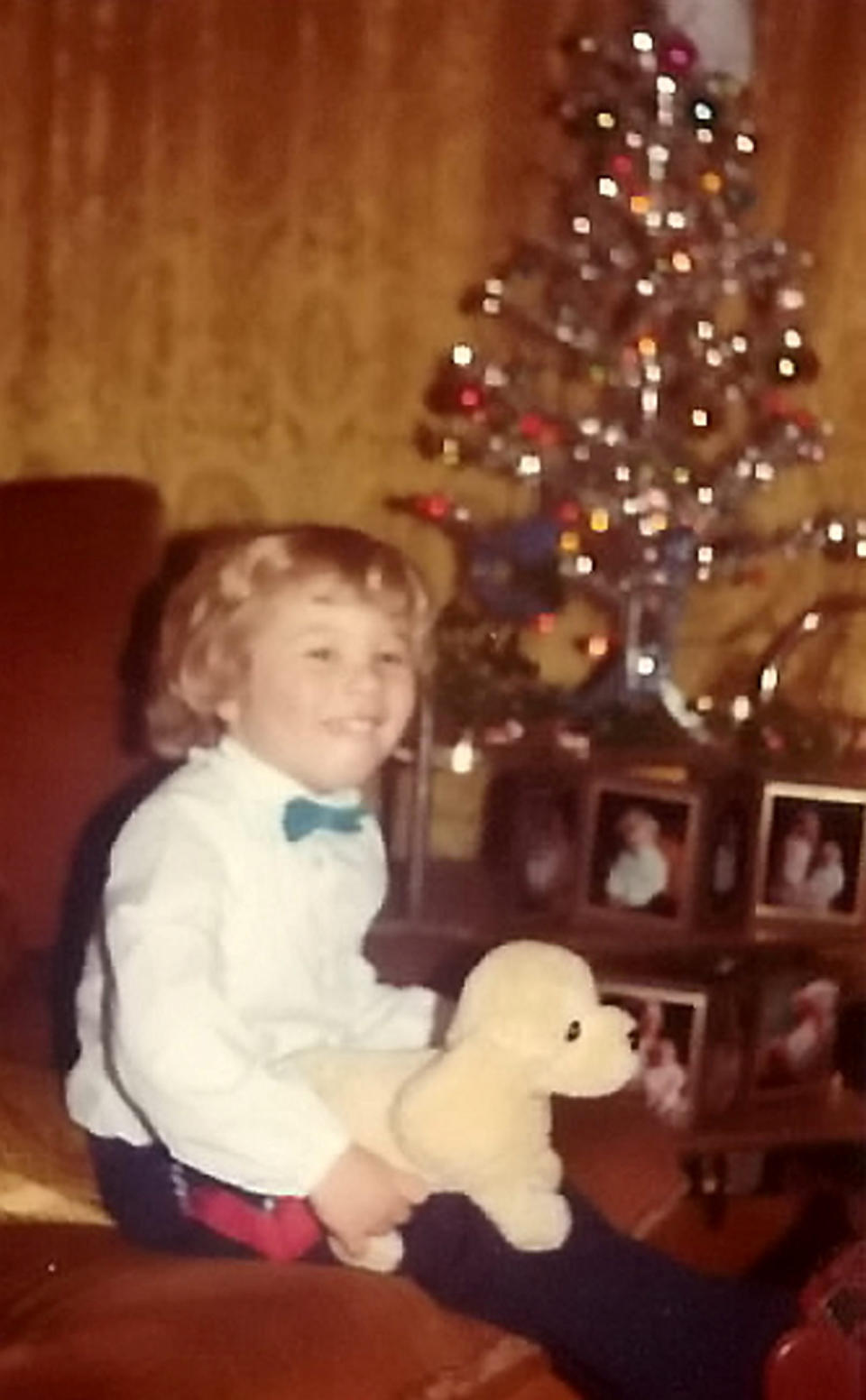 Ross Farr-Semmens of Plymouth pictured as a baby in 1982 looking at his christmas lights which are still working today. (SWNS)