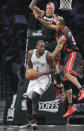 Miami Heat forward Rashard Lewis (9) and forward Chris Andersen (11) double-team Brooklyn Nets center Andray Blatche (0) in the first period during Game 3 of an Eastern Conference semifinal NBA playoff basketball game on Saturday, May 10, 2014, in New York. (AP Photo/Julie Jacobson)