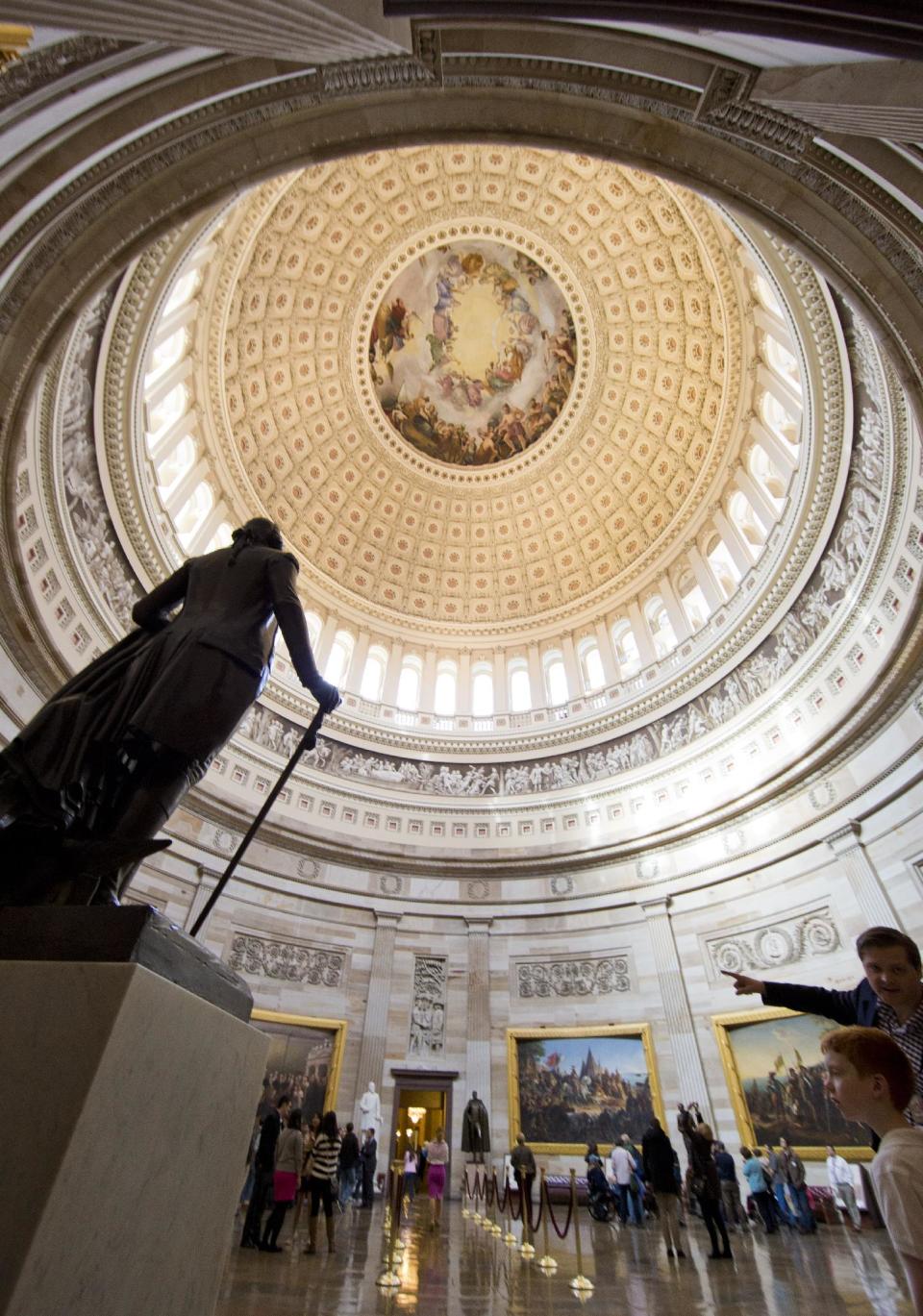 This March 1, 2013 photo shows visitors touring the Rotunda of the U.S. Capitol in Washington. There are probably more free things to do in the U.S. capital than nearly any other major city in the world. The most popular museums and the zoo are free, thanks to government funding, as well as the picturesque memorials and monuments. With so many free options, the biggest challenge might be narrowing down what to see. (AP Photo/Alex Brandon)