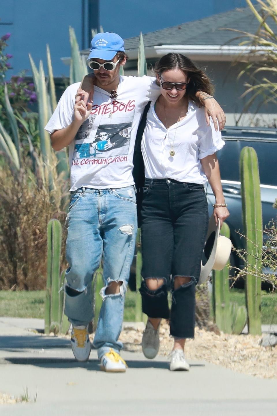 Los Feliz, CA  - *PREMIUM-EXCLUSIVE*  - So Happy together! Harry Styles and girlfriend Olivia Wilde looked all loved up while out for a stroll after enjoying lunch together on Sunday afternoon.  Harry sported a Beastie boys T-shirt, ripped jeans, sneakers and finished the casual look with his favorite with rimmed sunnies and a blue cap. Olivia sported ripped black denim and a white button down blouse and couldnâ€™t hide her glee as she walked with her arm wrapped around Harry. *Shot on August 8, 2021*

Pictured: Harry Styles, Olivia Wilde

BACKGRID USA 10 AUGUST 2021 

USA: +1 310 798 9111 / usasales@backgrid.com

UK: +44 208 344 2007 / uksales@backgrid.com

*UK Clients - Pictures Containing Children
Please Pixelate Face Prior To Publication*