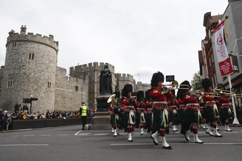 The Royal Regiment of Scotland band march by Windsor Castle, in Windsor, south England, Tuesday, May 7, 2019, a day after Prince Harry announced that his wife Meghan, Duchess of Sussex, had given birth to a boy. The as-yet-unnamed baby arrived less than a year after Prince Harry wed Meghan Markle in a spectacular televised event on the grounds of Windsor Castle that was watched the world over. (AP Photo/Alastair Grant)