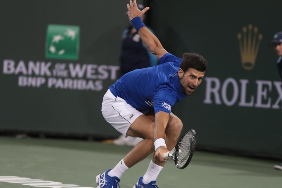 Novak Djokovic reaches for a shot from Bjorn Fratangelo at the BNP Paribas Open, Indian Wells, Calif., March 9, 2019.
