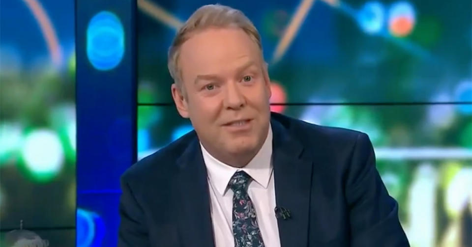 The Project host Peter Helliar wears a suit and blue patterned tie on set