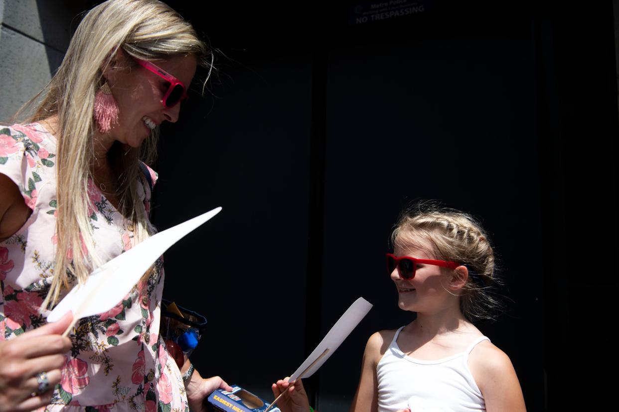 Brandy Kretz fans herself and Maley Kretz, 7, while the two wait in line on the fourth and final day of CMA Fest, on Broadway in Nashville , Tenn., Sunday, June 12, 2022. 