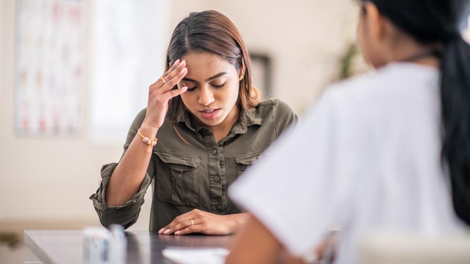 A frustrated woman is chatting with her mental health doctor.