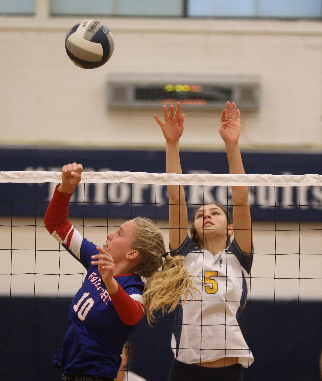 Fairport's Lana Wood and Thomas's Christina Newman pay the ball at the net.