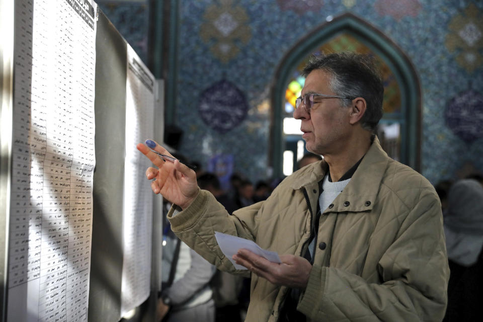 A voter fills out his ballot in the parliamentary elections at a polling station in Tehran, Iran, Friday, Feb. 21, 2020. Iranians began voting for a new parliament Friday, with turnout seen as a key measure of support for Iran's leadership as sanctions weigh on the economy and isolate the country diplomatically. (AP Photo/Ebrahim Noroozi)