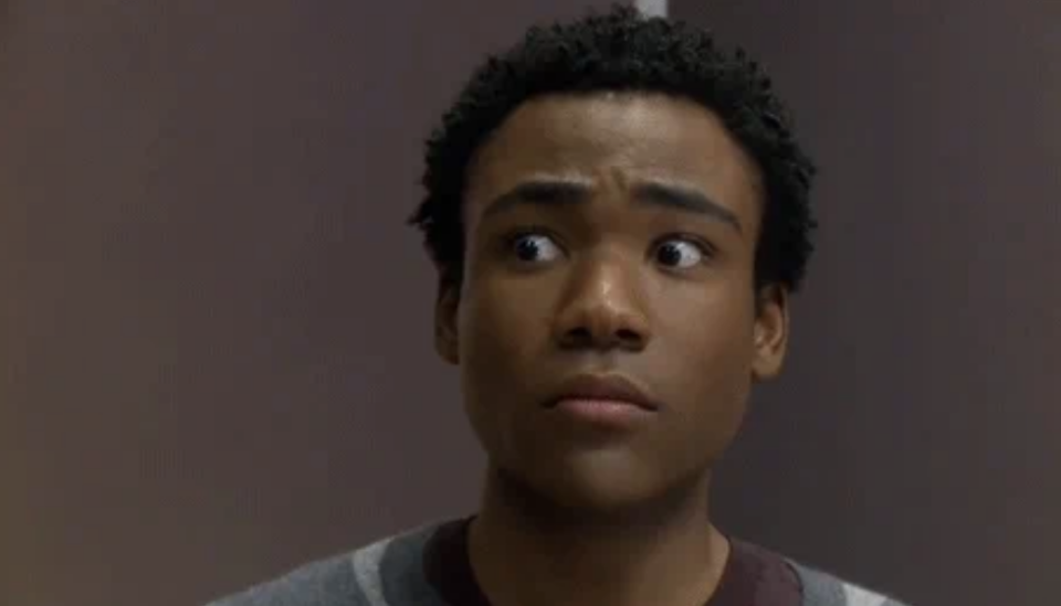 Donald Glover looking surprised, eyes wide open and glancing to his left