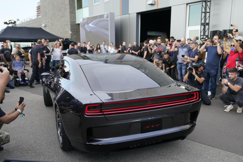 The Dodge Charger Daytona SRT concept is unveiled, Wednesday, Aug. 17, 2022, in Pontiac, Mich. Thundering gas-powered muscle cars will be closing in on their final Saturday night cruises in the coming years as automakers begin replacing them with super-fast cars that run on batteries. (AP Photo/Carlos Osorio)