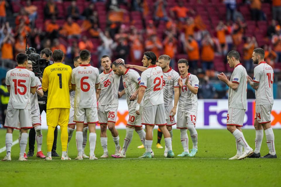 North Macedonia's Goran Pandev, center, leaves the pitch while applauded and embraced by teammates during the Euro 2020 soccer championship group C match between The Netherlands and North Macedonia at the Johan Cruyff ArenA in Amsterdam, Netherlands, Monday, June 21, 2021. (AP Photo/Peter Dejong, Pool)