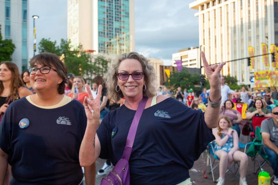 A Riverfest attendee poses for a photo during a concert Friday by Tag Team, a hip-hop duo. The concert was one of the last events of the evening before the festival shut down early due to possible bad weather.