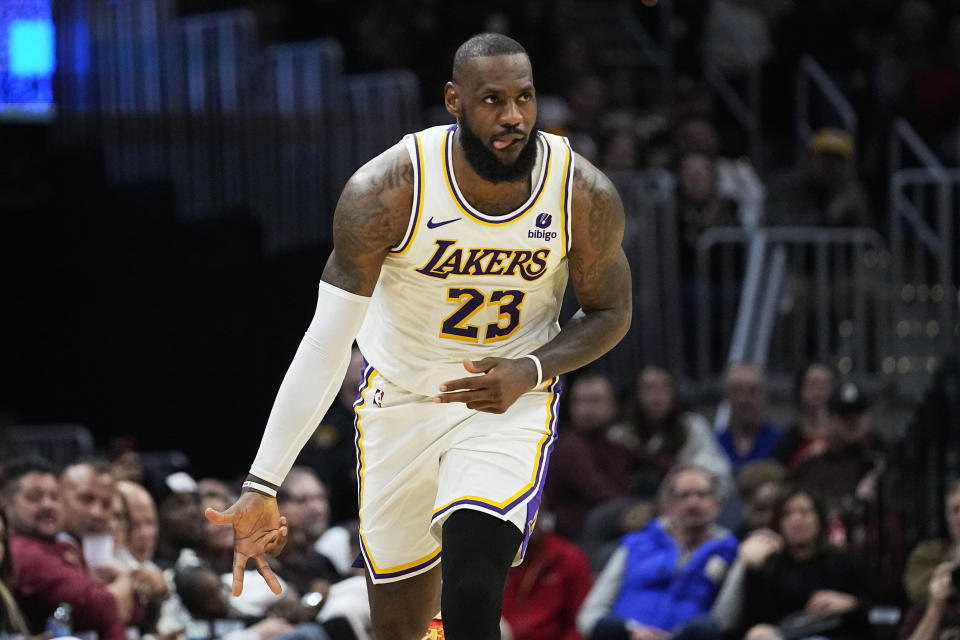 Los Angeles Lakers forward LeBron James (23) gestures after hitting a 3-point shot against the Cleveland Cavaliers during the second half of an NBA basketball game Saturday, Nov. 25, 2023, in Cleveland. (AP Photo/Sue Ogrocki)