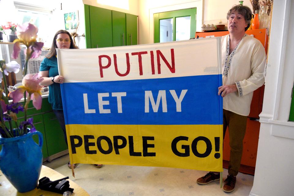 Maiia Dvokina, left, and David Halbout hold a sign the Halbouts designed after the 2014 invasion of Crimea by Russia on Saturday, May 21, 2022 in Middletown, New Jersey. 