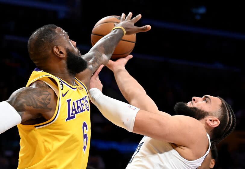 Los Angeles, California April 24, 2023-Lakers LeBron James fouls Grizzlies Davis Roddy in the second quarter at Crypto.com arena Monday. (Wally Skalij/Los Angeles Times)