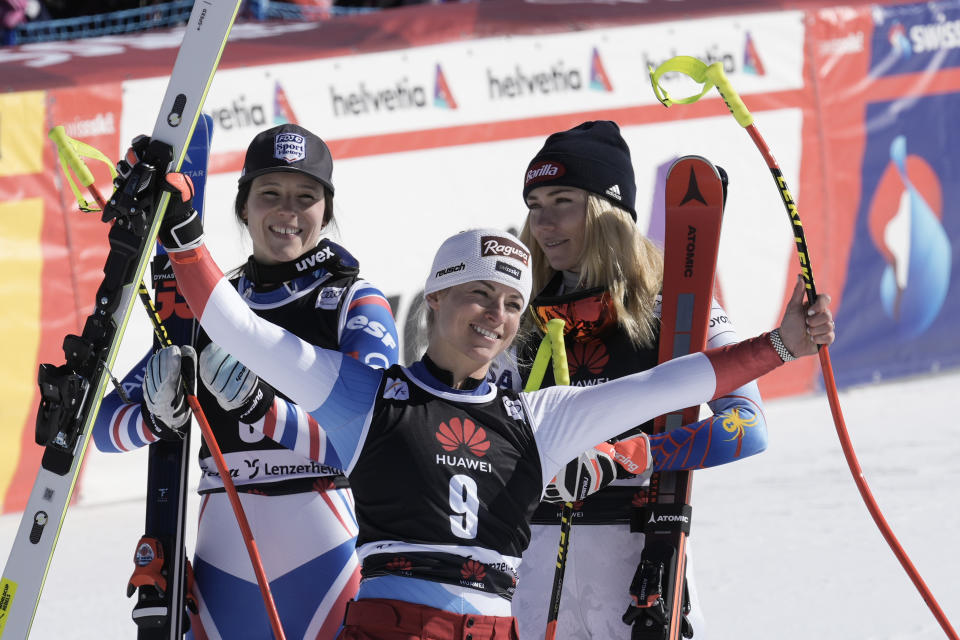 From left, winner France's Romane Miradoli, third placed Switzerland's Lara Gut Behrami and second placed United States' Mikaela Shiffrin celebrate in the finish area of an alpine ski, women's World Cup super-G, in Lenzerheide, Switzerland, Saturday, March 5, 2022. (AP Photo/Giovanni Auletta)