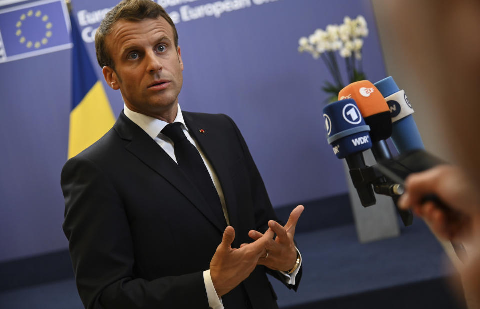 French President Emmanuel Macron speaks with the media during an EU summit at the Europa building in Brussels, Friday, June 21, 2019. European Union leaders have failed to back a plan to make the bloc's economy carbon neutral by 2050 in spite of promises to fight harder against climate change. (AP Photo/Riccardo Pareggiani)