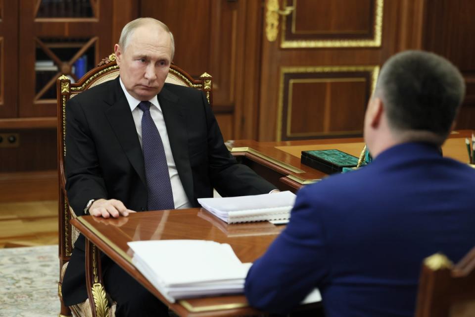 Russian President Vladimir Putin, left, meets with Prosecutor General Igor Krasnov at the Kremlin in Moscow, Russia (AP)