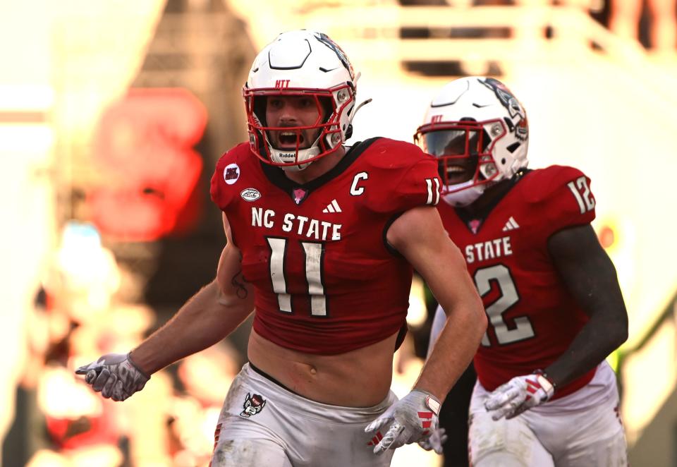 North Carolina State Wolfpack linebacker Payton Wilson (11) celebrates after scoring a touchdown on an interception during the second half against the Clemson Tigers at Carter-Finley Stadium.