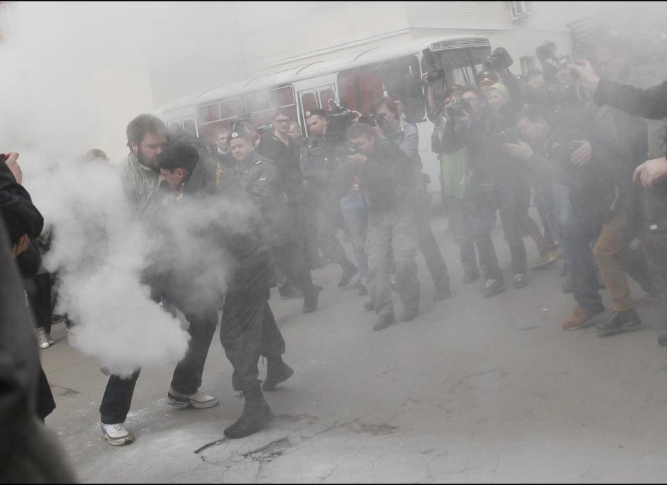 Police detain supporters of Pussy Riot outside a court in Moscow, Russia, Thursday, April 19, 2012. 