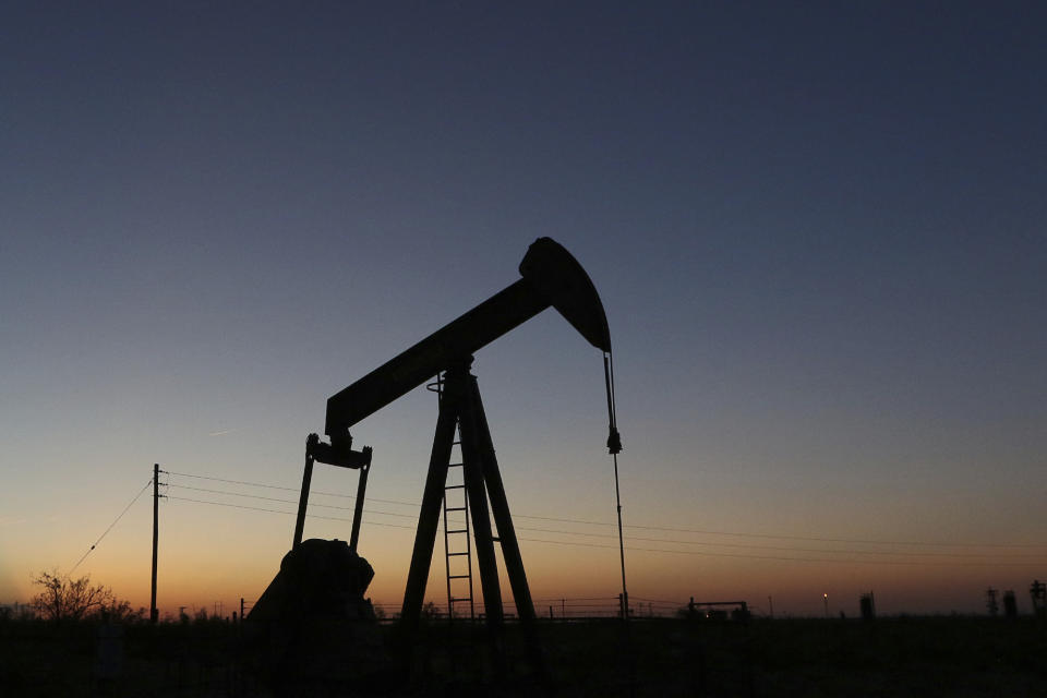 FILE - In this June 11, 2019, photo a pump jack operates in an oil field in the Permian Basin in Texas. The world may be heading into an oversupply of oil, and that possibility is hanging over members of the OPEC cartel, which will meet later this week to decide whether to further cut production to boost prices. (Jacob Ford/Odessa American via AP, File)